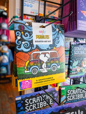 Colorful Peanuts scratch art kit on display at a store.